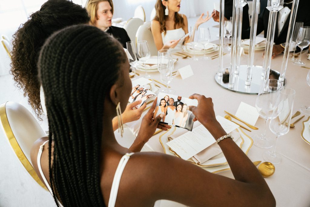 Guests looking at photo prints taken by a photo booth