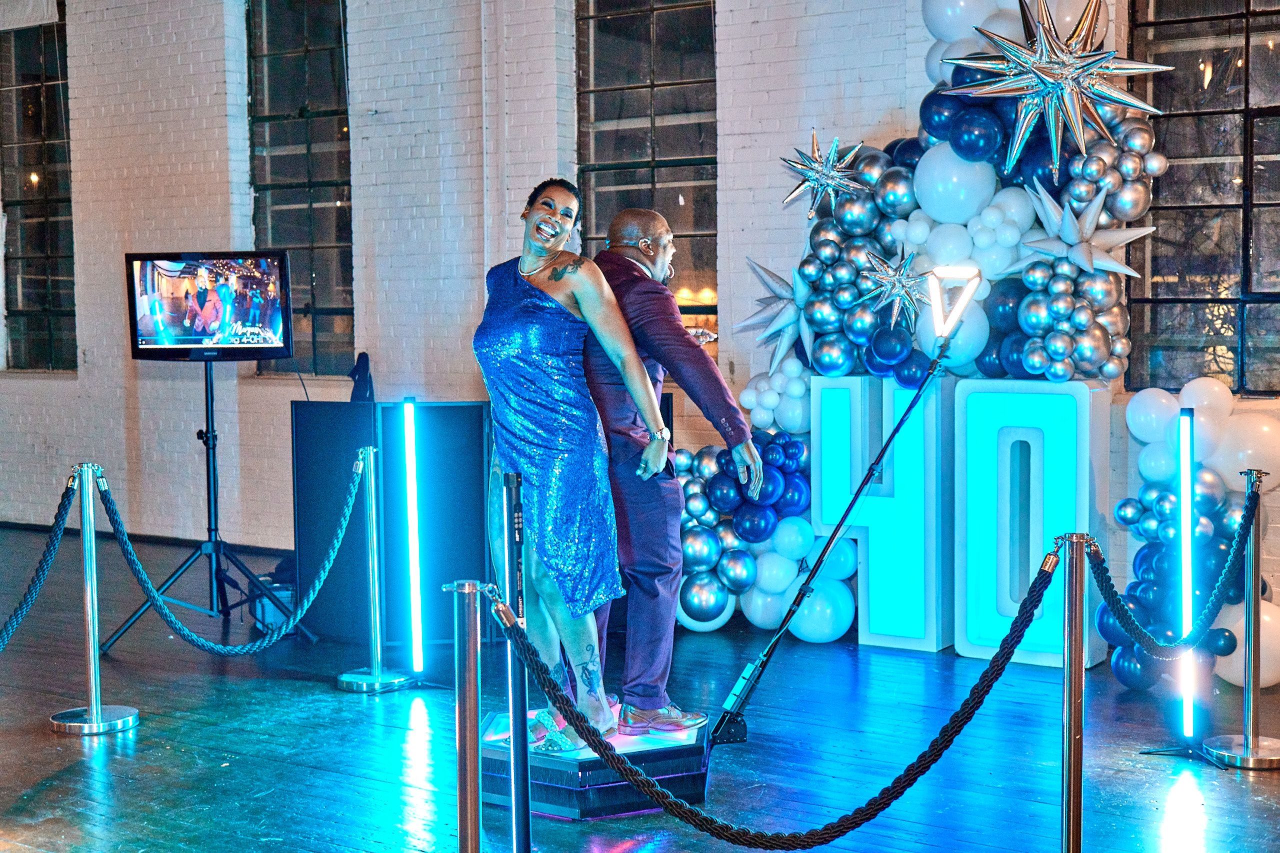 People enjoying a 360 photo booth during a 40th birthday celebration party